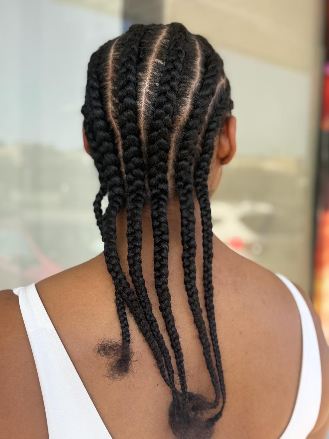medium black neat feed in cornrows back view
